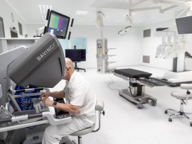 Operatér sedí u speciální konzole. Pacient leží vedle.